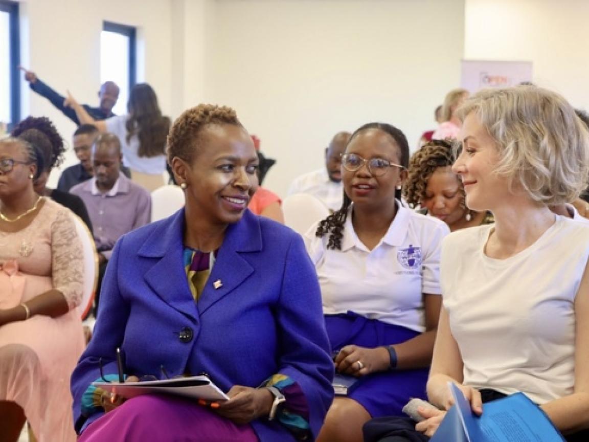 People sitting, 2 women talking to each other