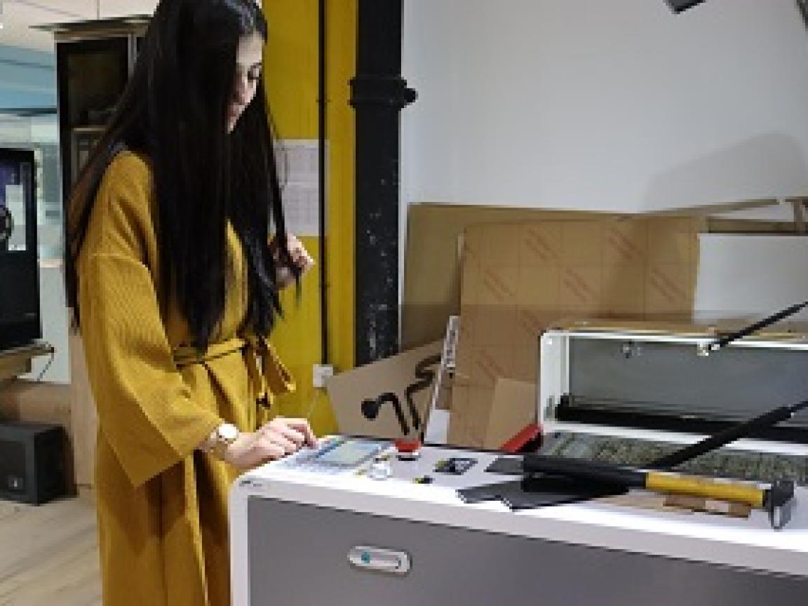 A woman operating a recycling machine