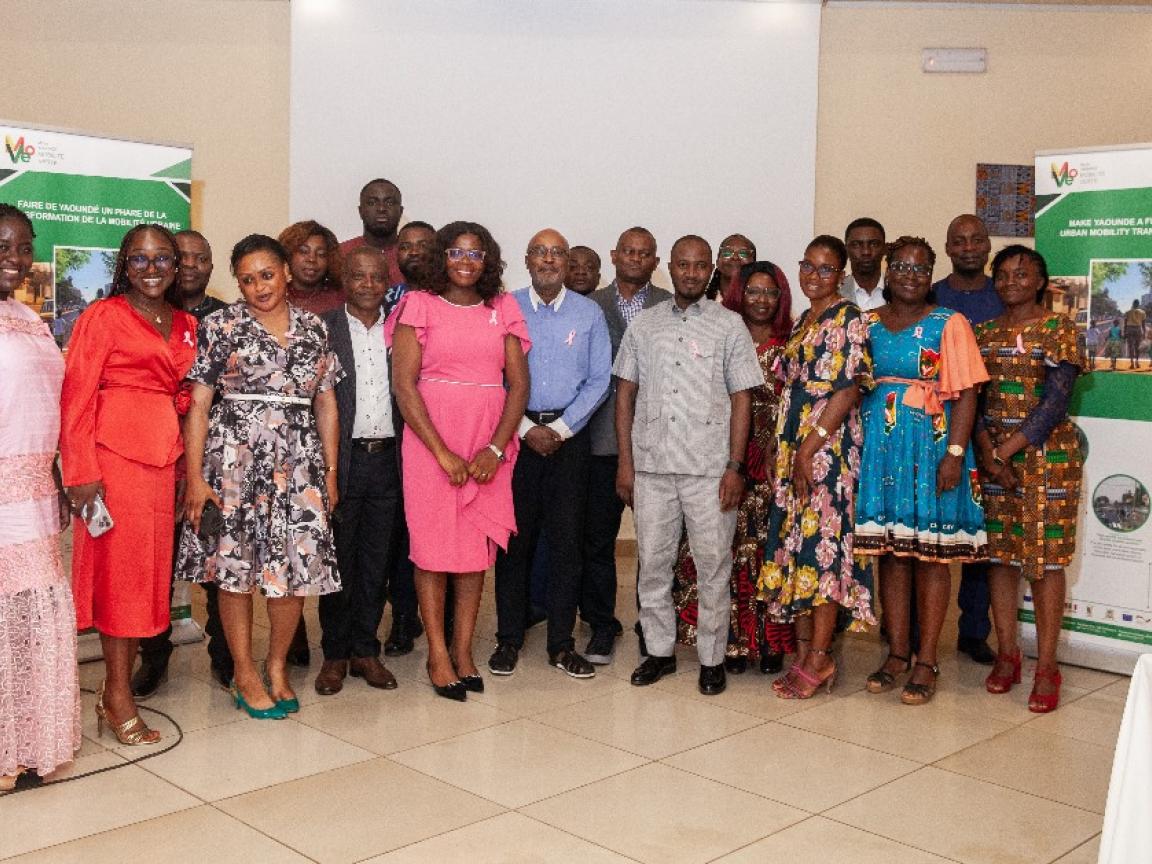 A group of men and women are taking a group picture.