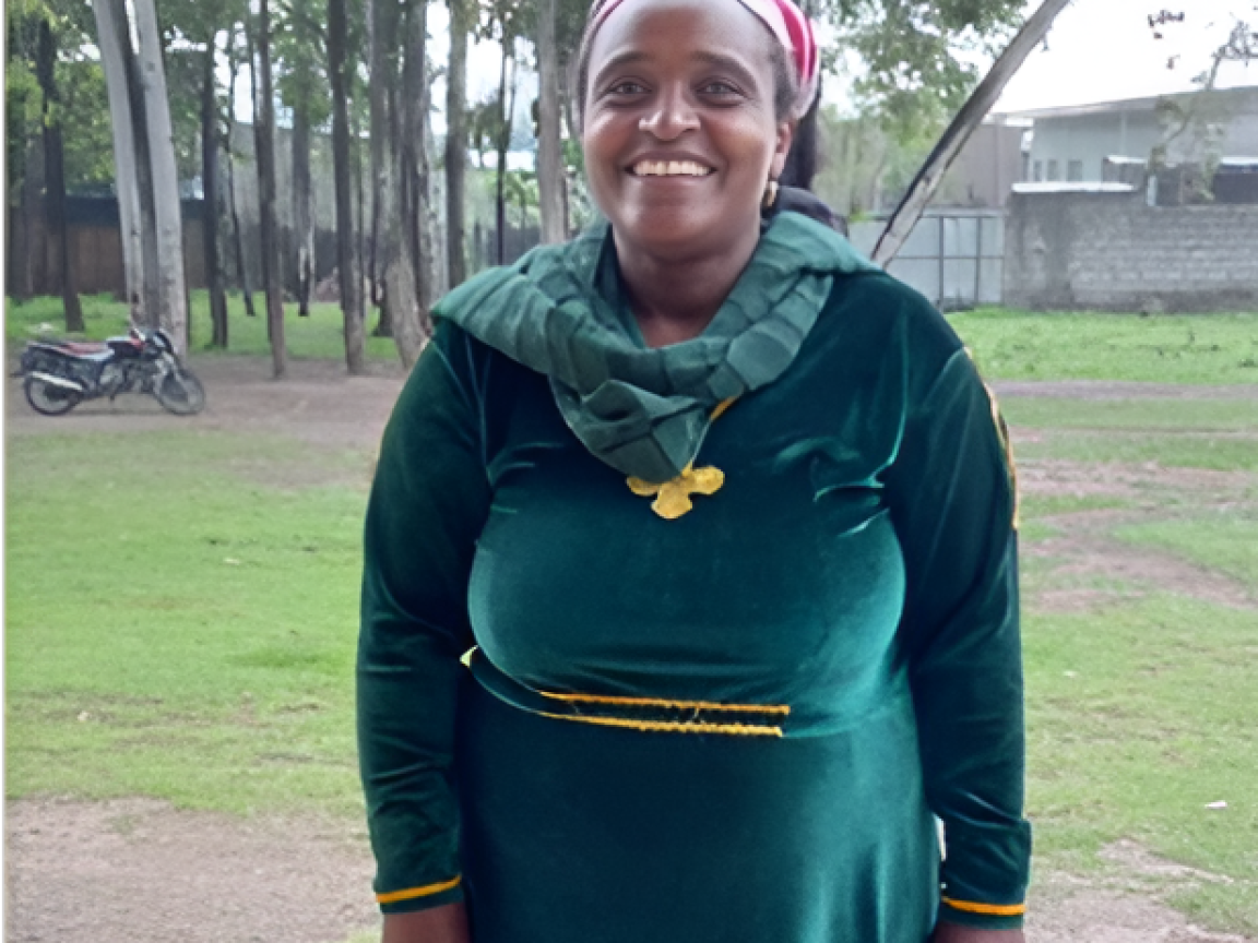A woman wearing green dress, a green scarf and smiling