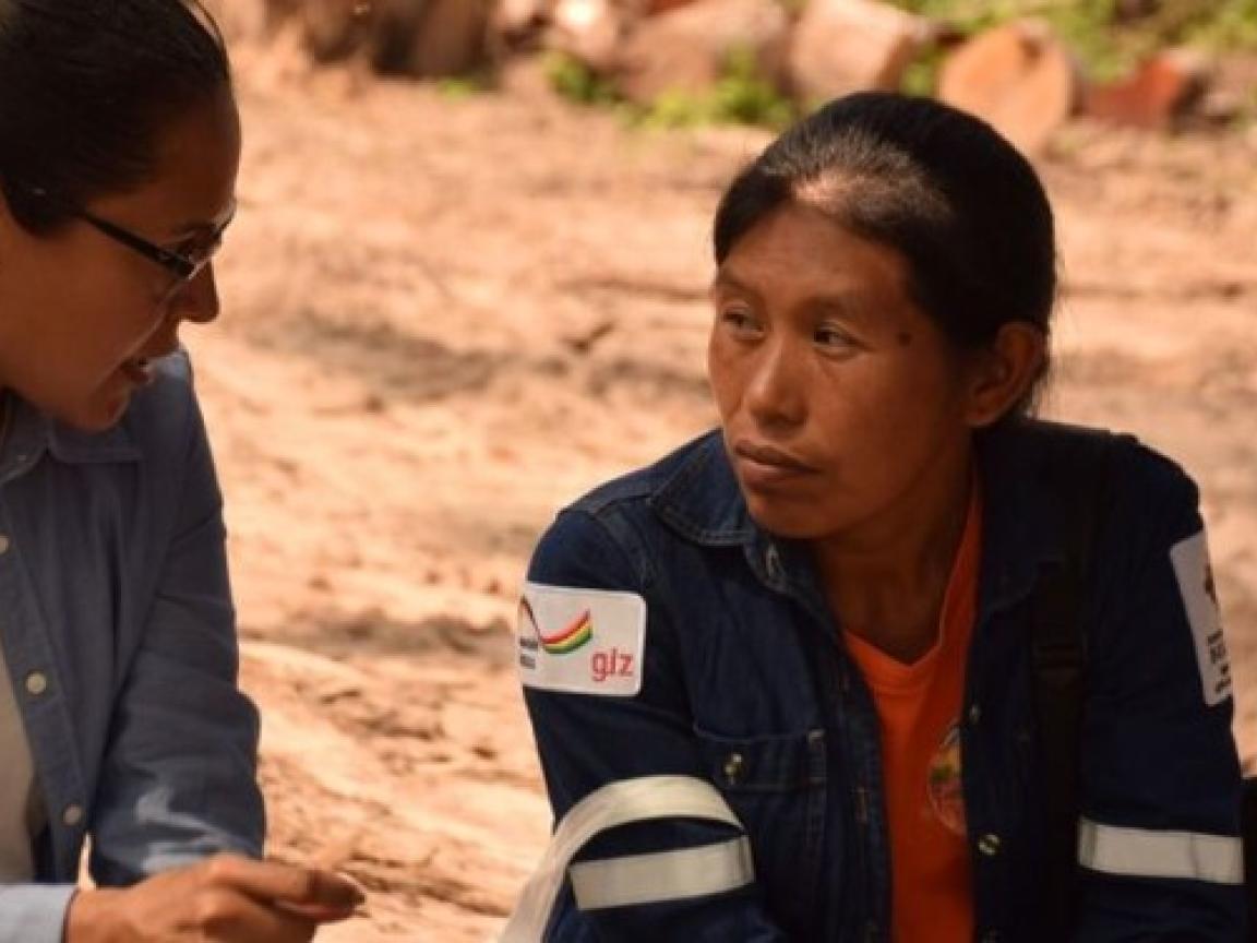Two women are speaking with each other.