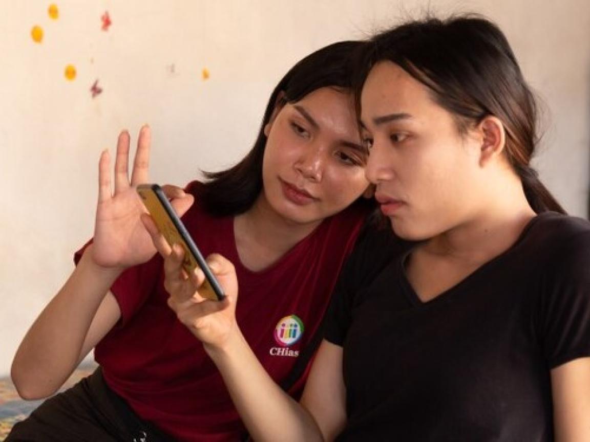 Zwei junge Frauen sehen auf ein Smartphone.