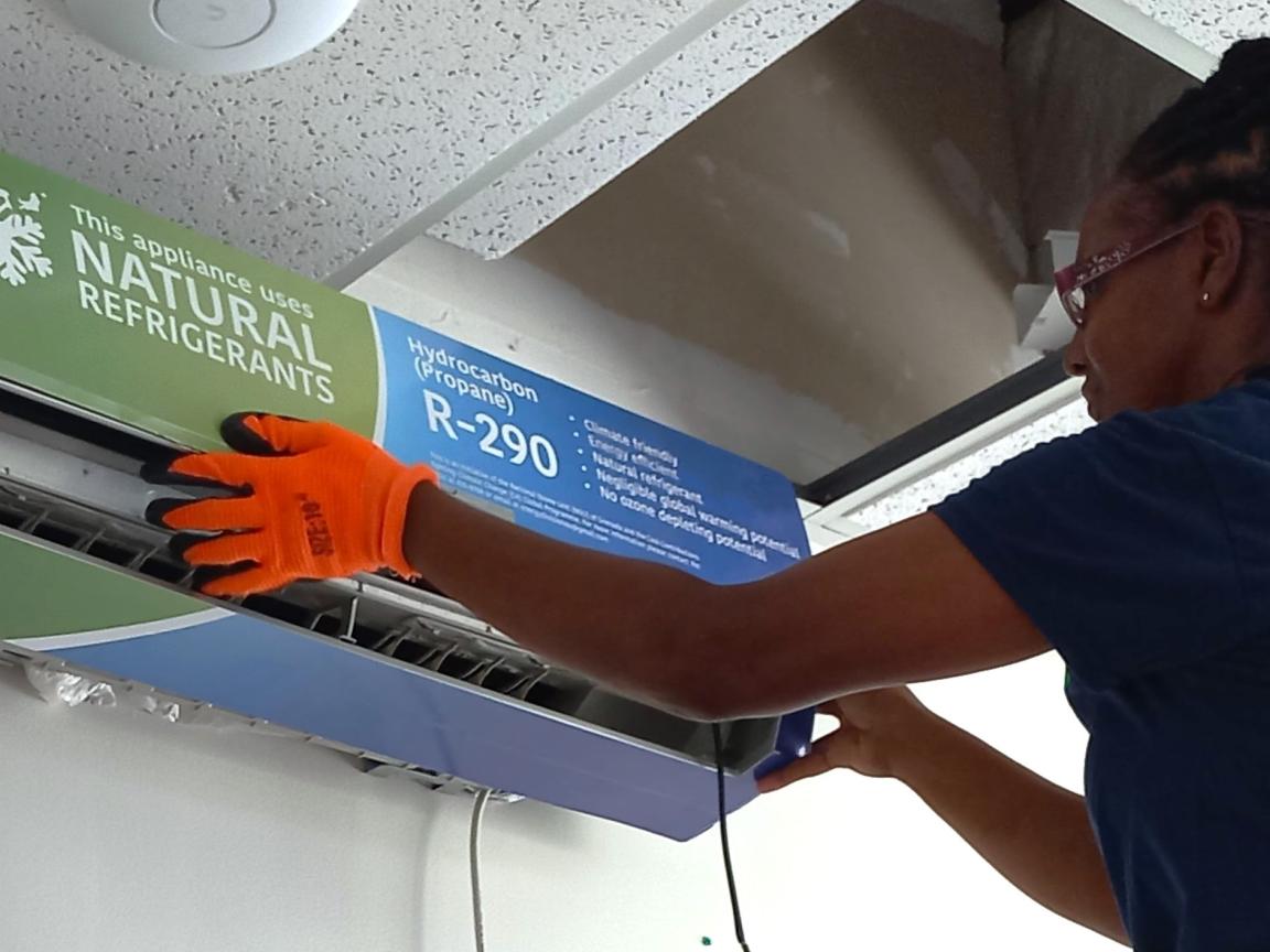 A woman installs an air conditioning system