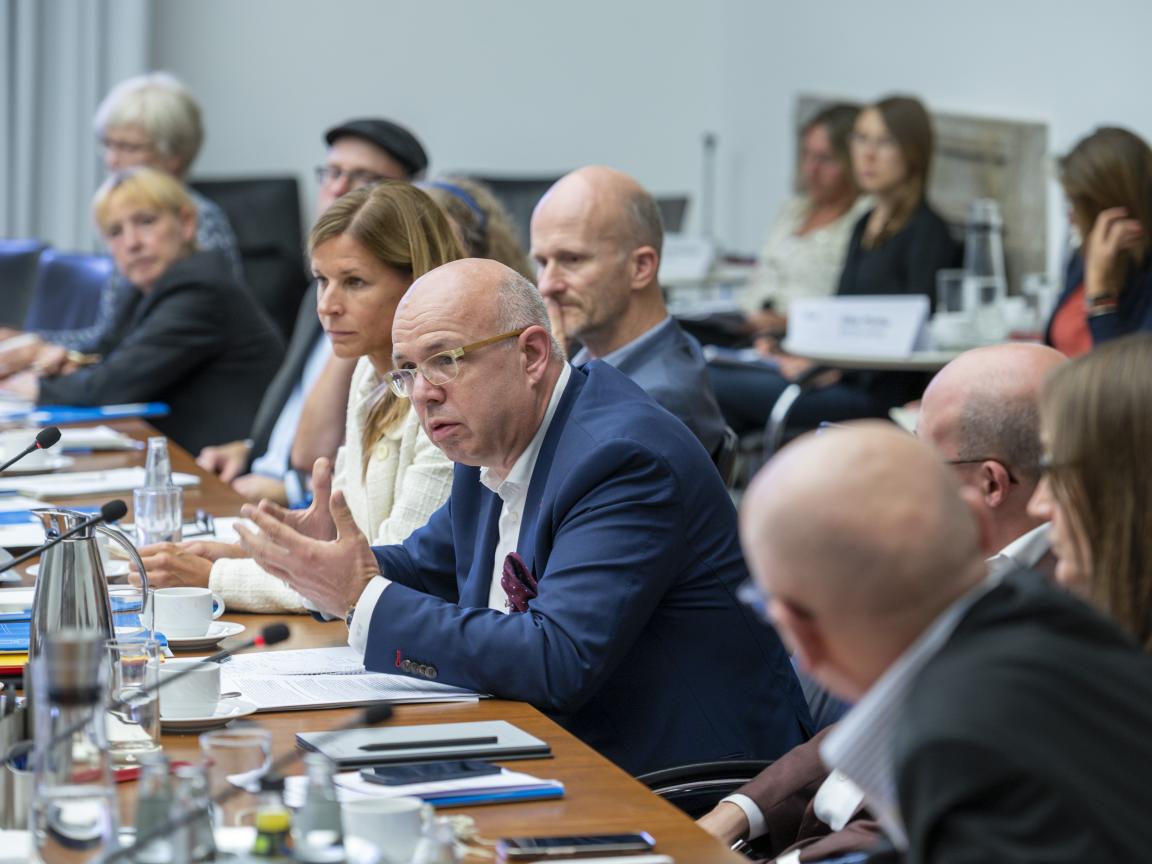 Company representatives sit round a table and discuss