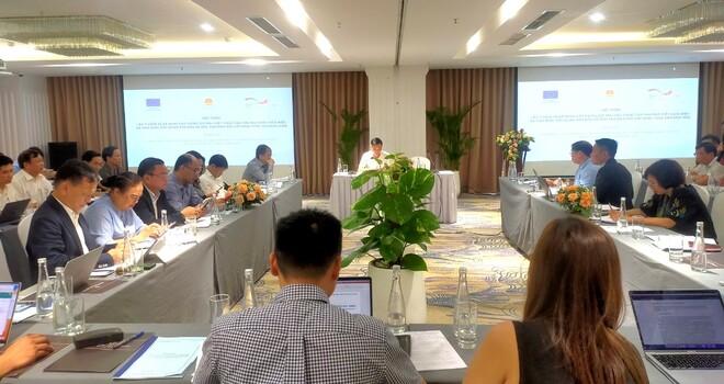 People sitting at tables listening to a presentation