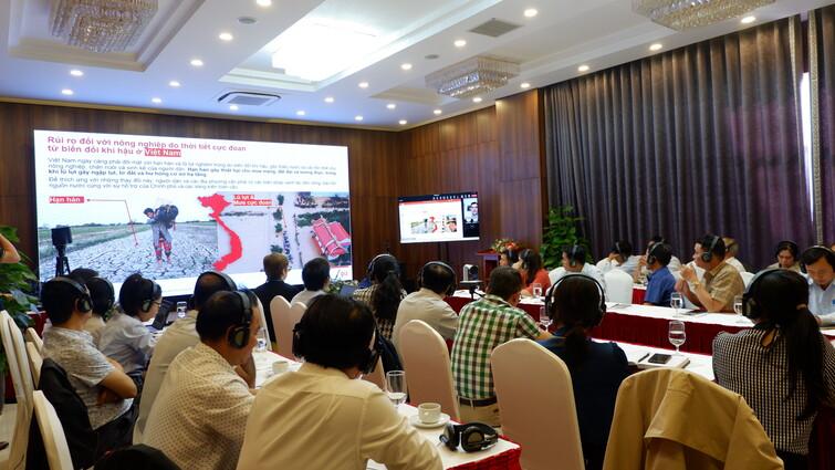 People sitting at tables listening to a presentation