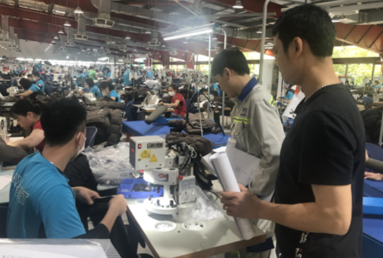 People working in a clothing warehouse