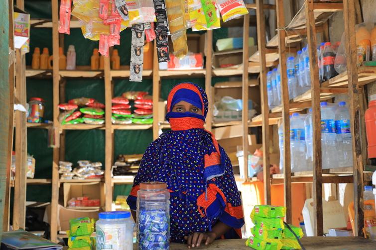 Woman sits in her shop