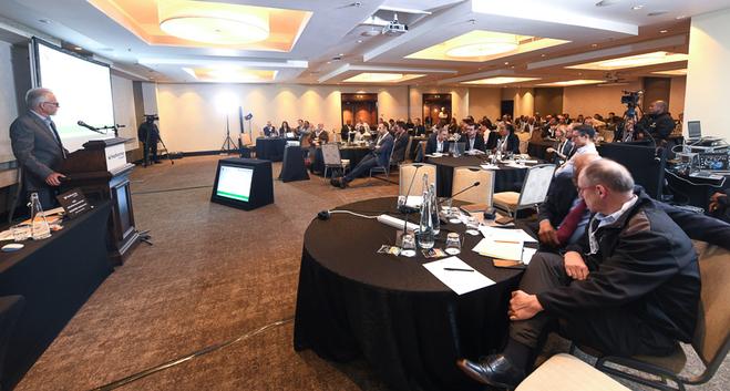 People sitting at tables listening to a presentation
