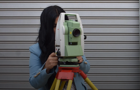 A woman operating a surveying instrument