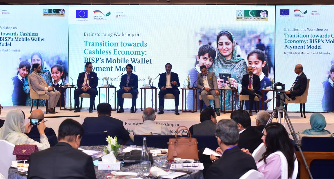 Panelists sitting on a stage during a panel discussion.
