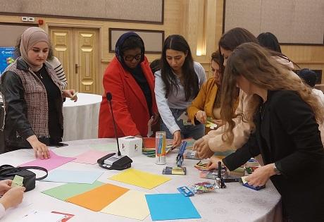 Women gathered around a table participating in a workshop