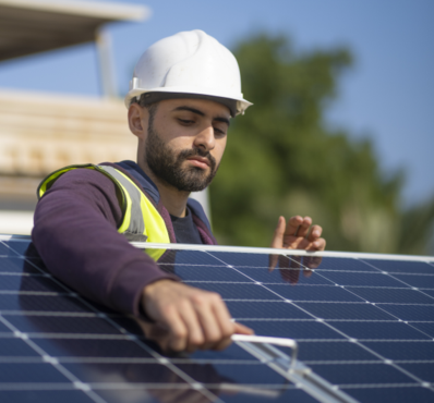 Worker installing solar panels