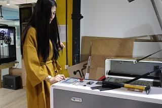 A woman operating a recycling machine