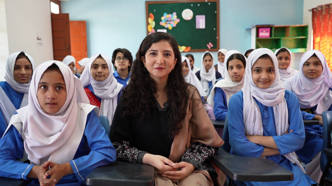 Young school girls pose for a group picture