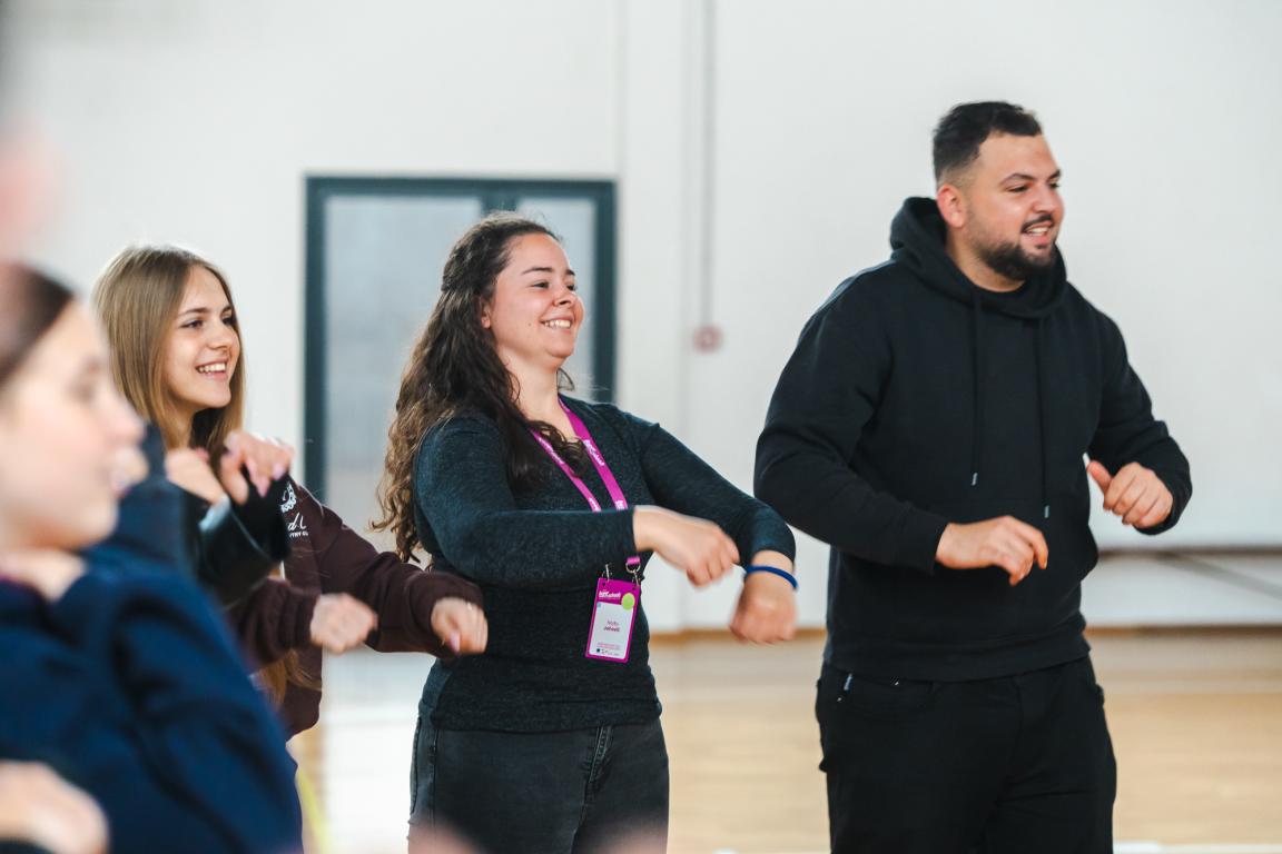 Young participants smiling and taking part in a group activity during a Superschools exchange.