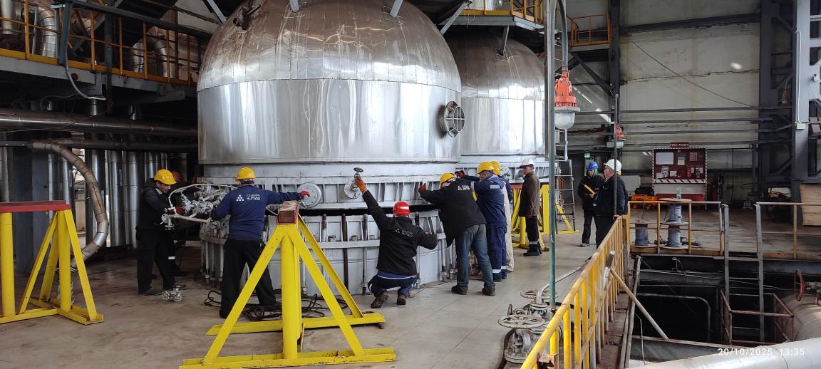 Workers install an exhaust gas system in a Georgian fertiliser factory.
