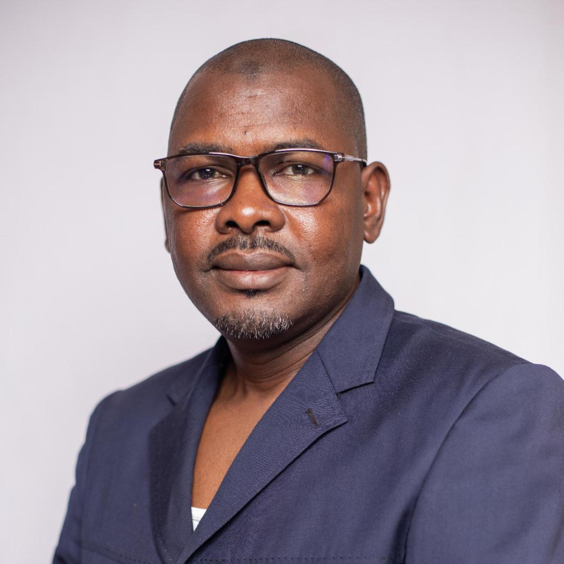 Man in business outfit looking into the camera. 