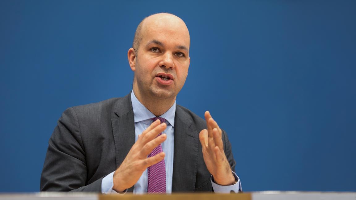 Marcel Fratzscher, im Anzug mit Krawatte vor blauem Hintergrund, der beim Sprechen beide Hände gestikulierend vor sich hält.