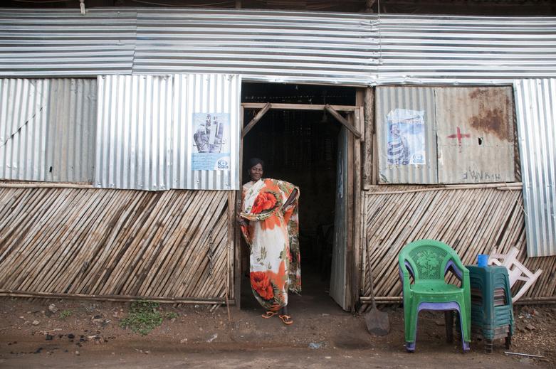 A woman standing in the entrance to a building.