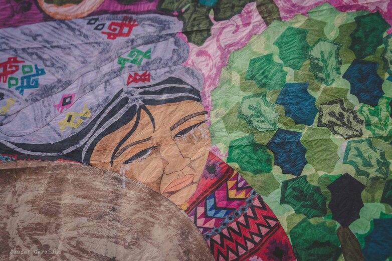 A painting with a woman and a tree.