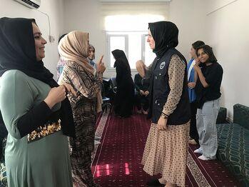 Women stand together and do a role-play exercise.