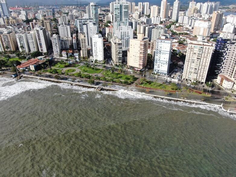 The skyline of a city at a coastline which is being hit by a storm.