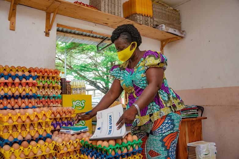 A woman stocktaking in a storeroom with eggs.