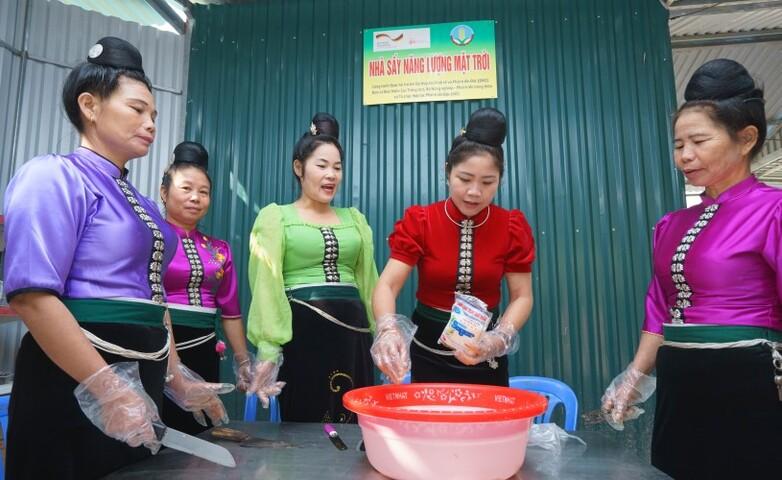Women are working to process food.