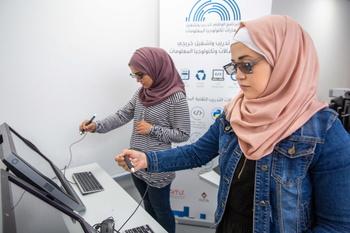 Two female students participating in the up-skilling programme work with an Augmented Reality Tool