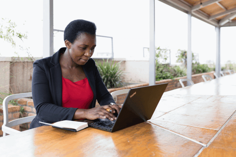 Woman typing on a laptop.