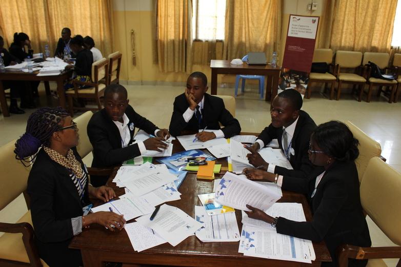 People sitting together at a table during a workshop. Copyright: GIZ