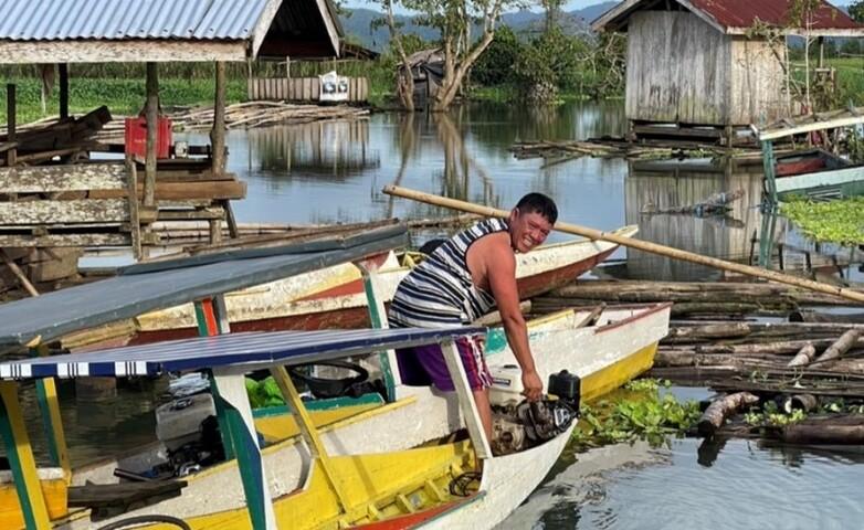 A man is working on a boat.