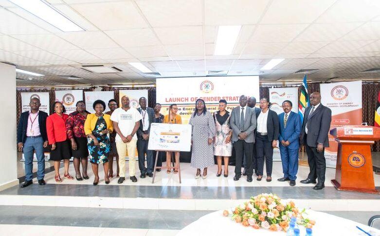A group of people in a conference room in front of banners.