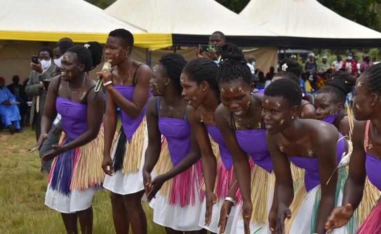 Women performing a dance during a cultural gala promoting social cohesion between refugees and host communities in Uganda.