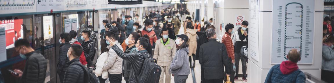 Viele Menschen stehen an einem U-Bahngleis in China.
