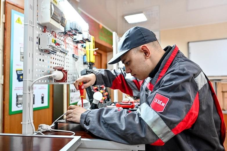 A man inserting a screw in a workshop.