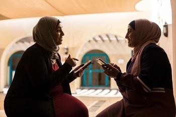Two women with smart phones.