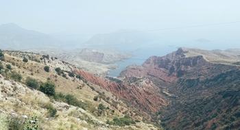 A mountainous landscape with a river flowing through it