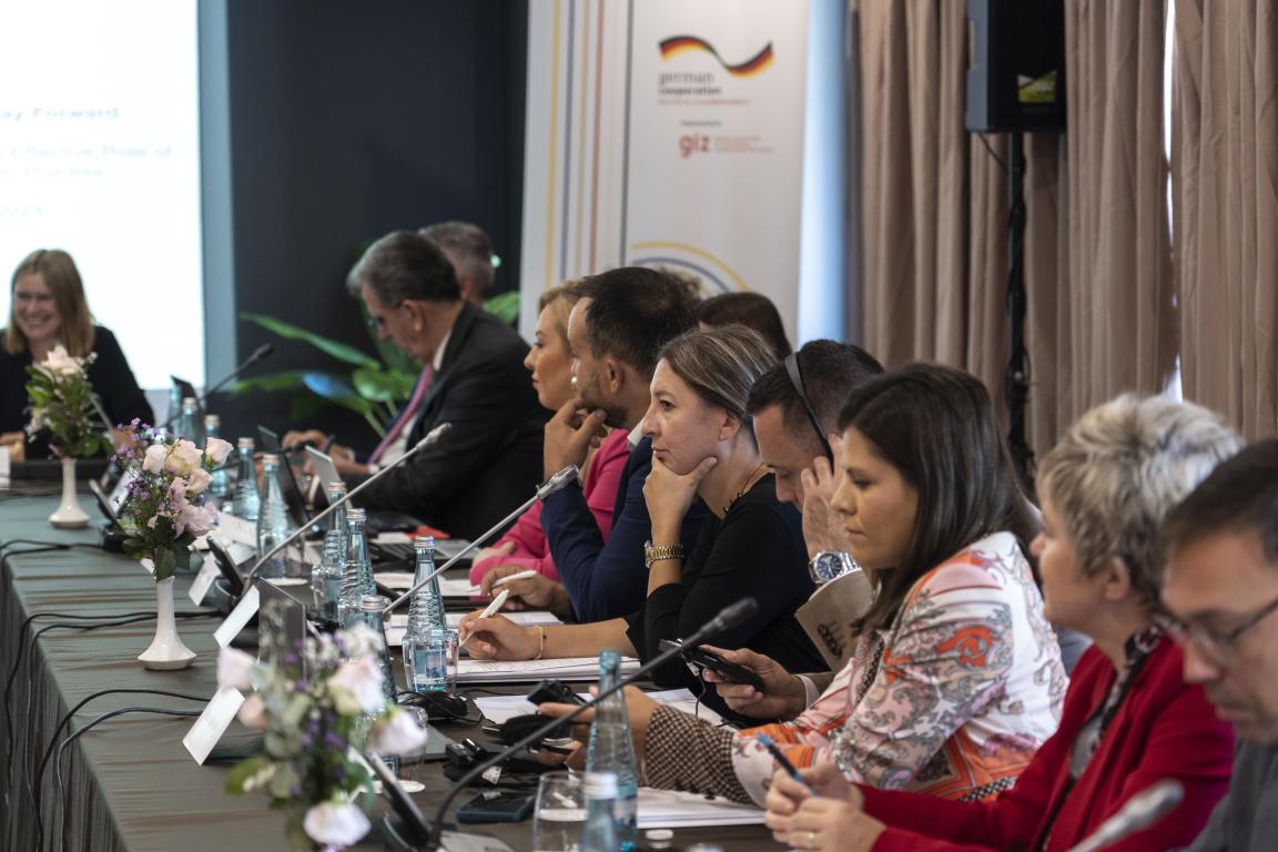 Participants seated at a conference table during a regional cooperation meeting in the Western Balkans, discussing EU integration strategies.