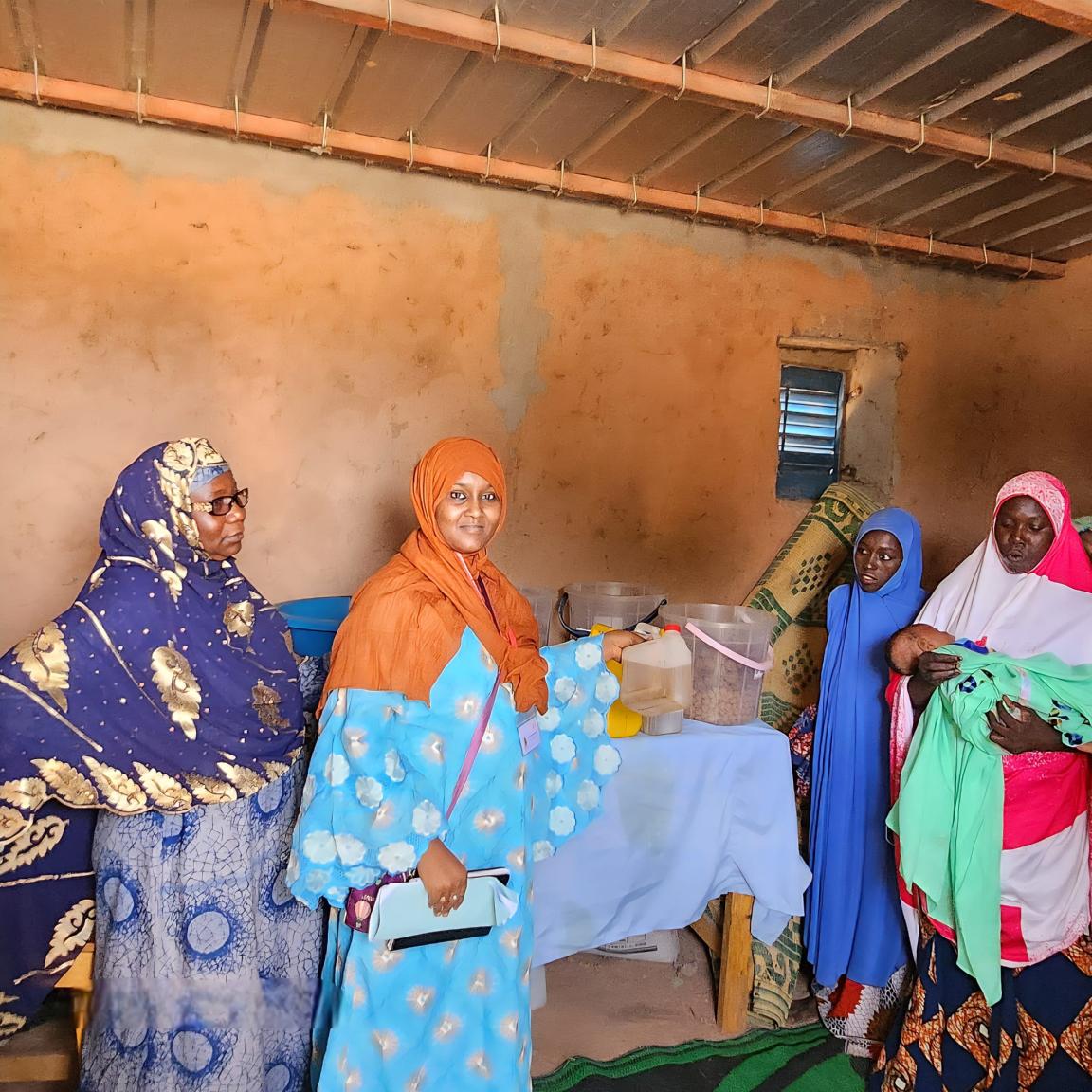 A group of refugee women in Niger making groundnut oil.