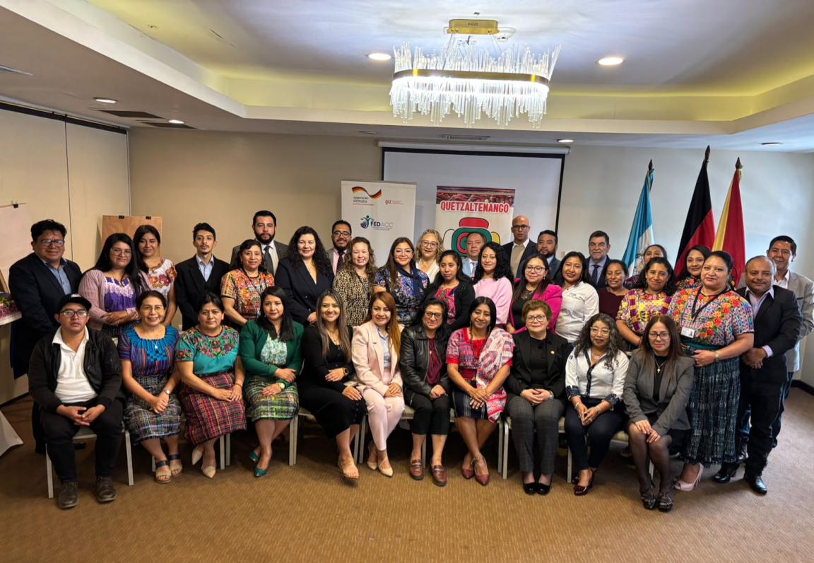 Representatives of judicial authorities and civil society organisations standing and sitting together for a photo during a training session.