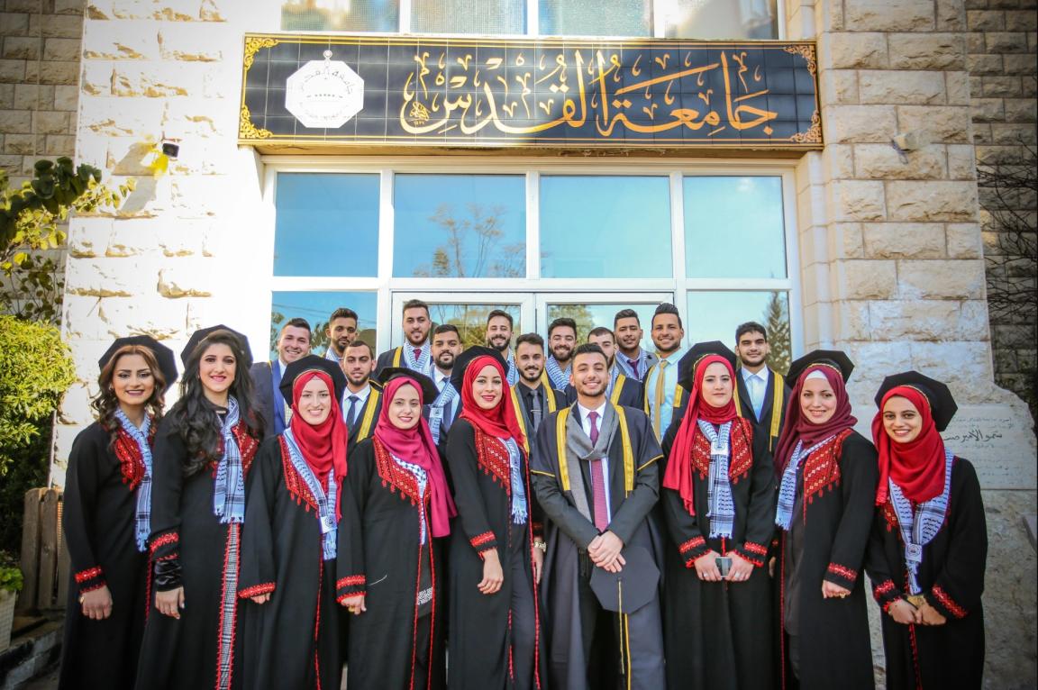 A group of people are standing in front of a building.