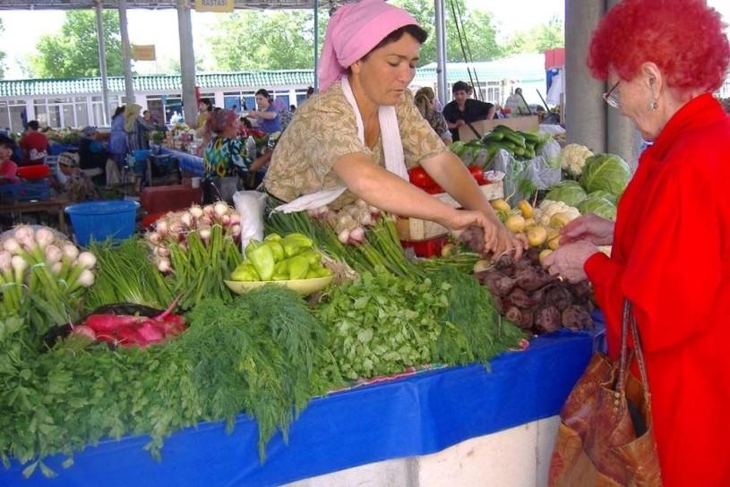 A saleswoman and a customer at a vegetable stall.