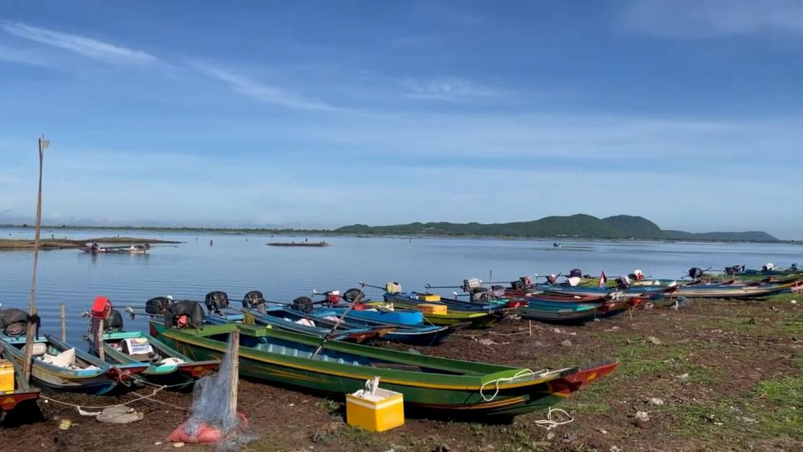 Several fishing boats can be seen at sea.