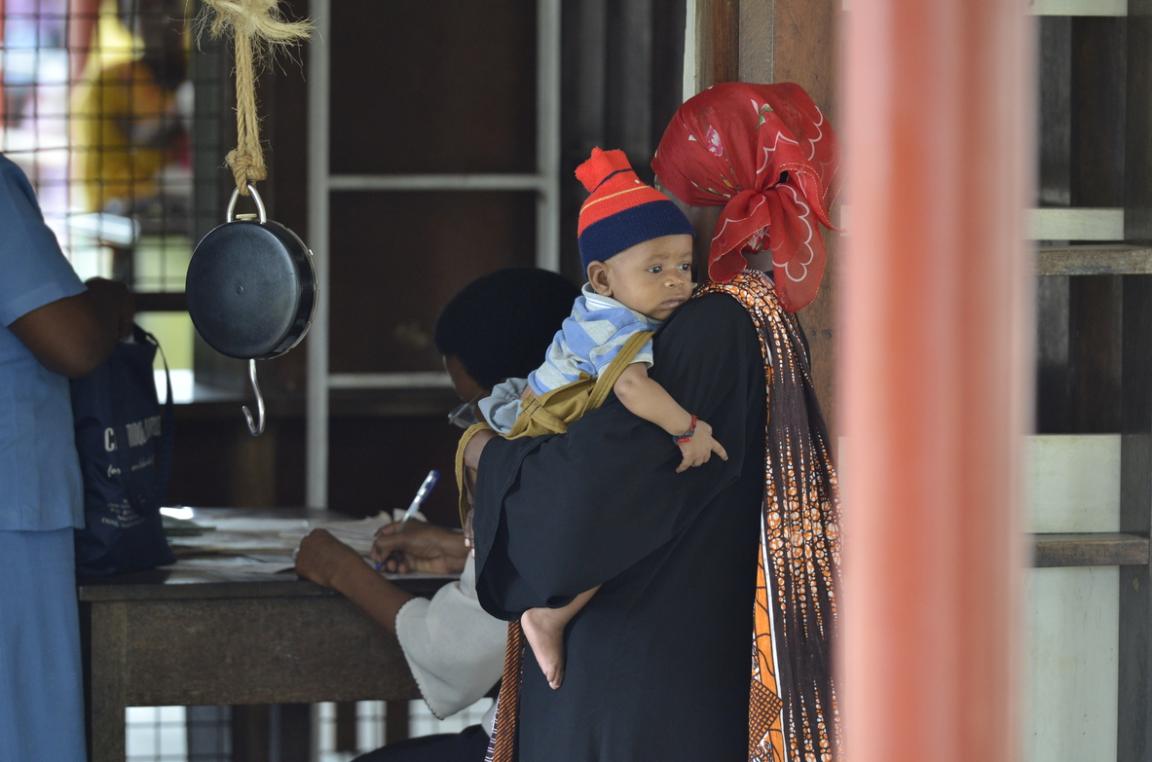 A mother holds her baby at a medical practice.