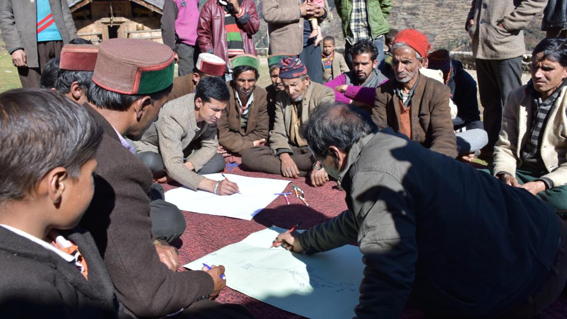 Community members participate in a group discussion and mapping exercise to document local biodiversity and traditional knowledge.