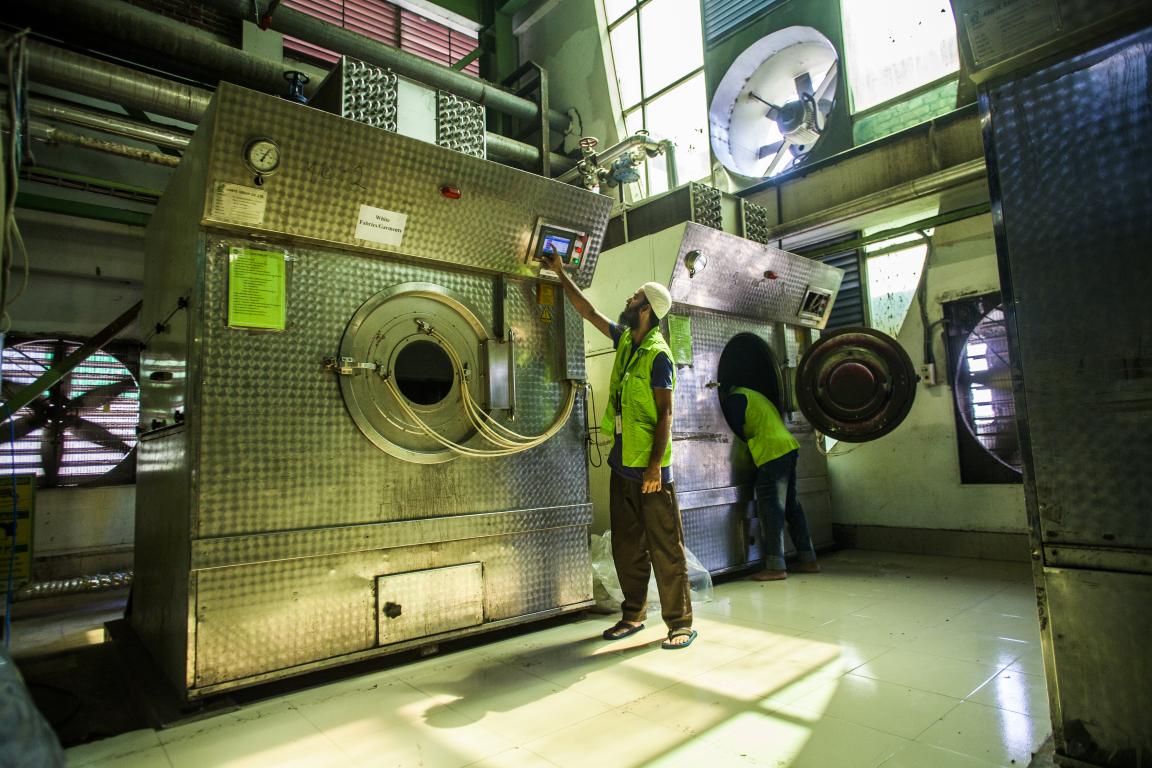 A worker operates a machine in a textile factory in Bangladesh.