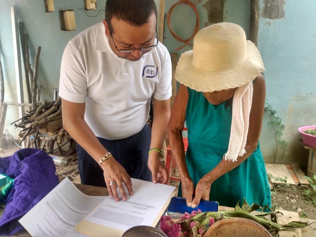 A male public defender advising an older woman.