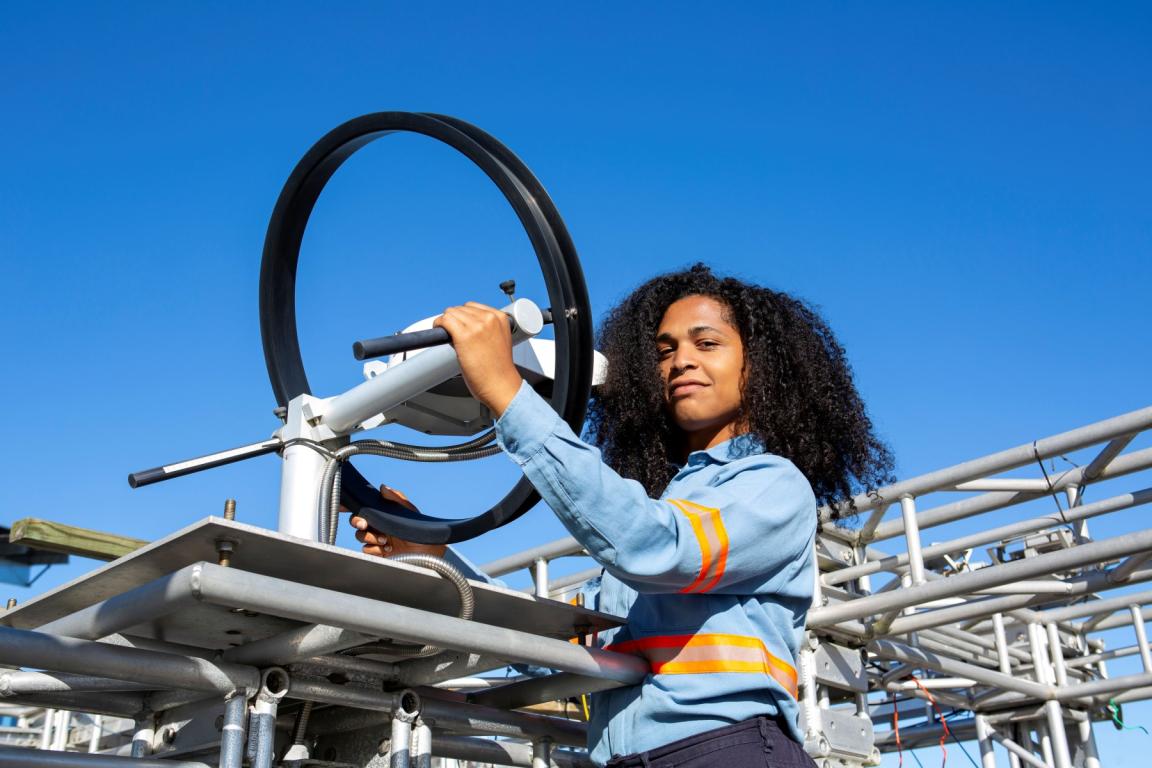 A lady worker is working on an installation. 